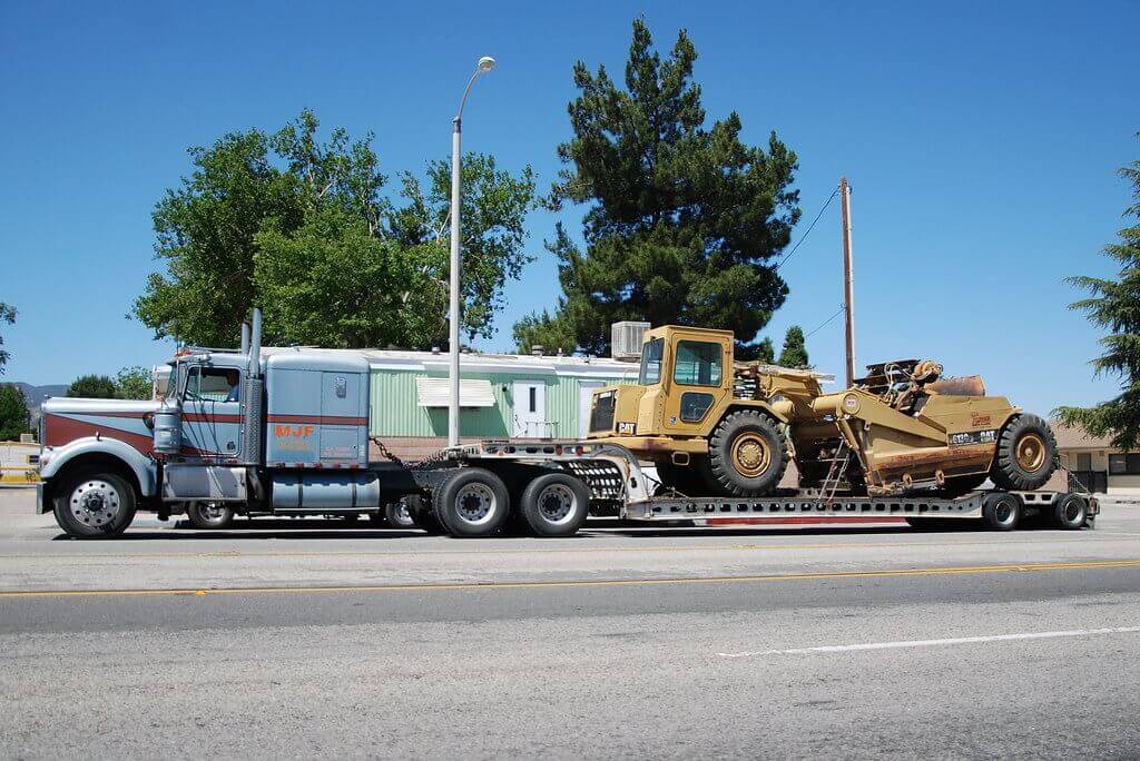 flatbed trailer with construction vehicle